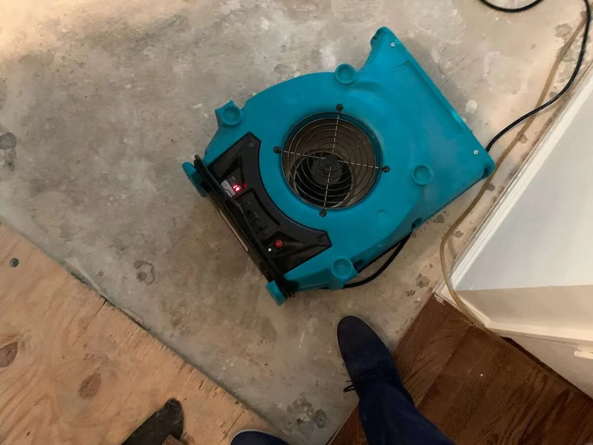 Air mover drying subfloor during Leak Detection & Repair in Moab
